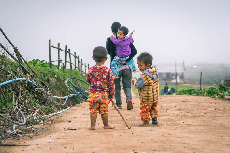 Mother takes his son home from friends in countryside in Thailand