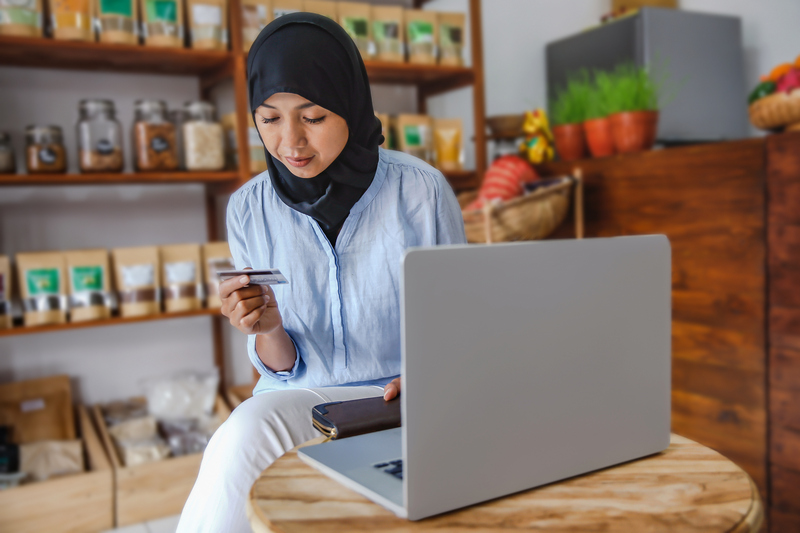 Woman sits in front of laptop