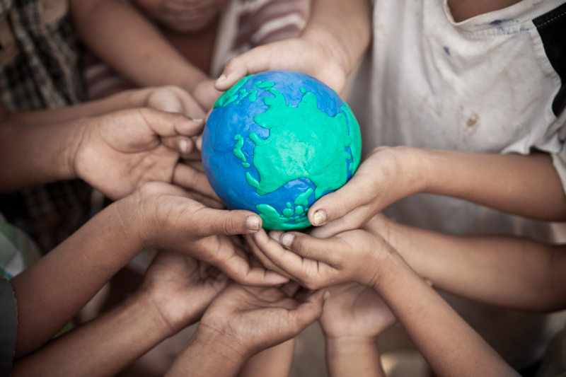 Hands holding globe